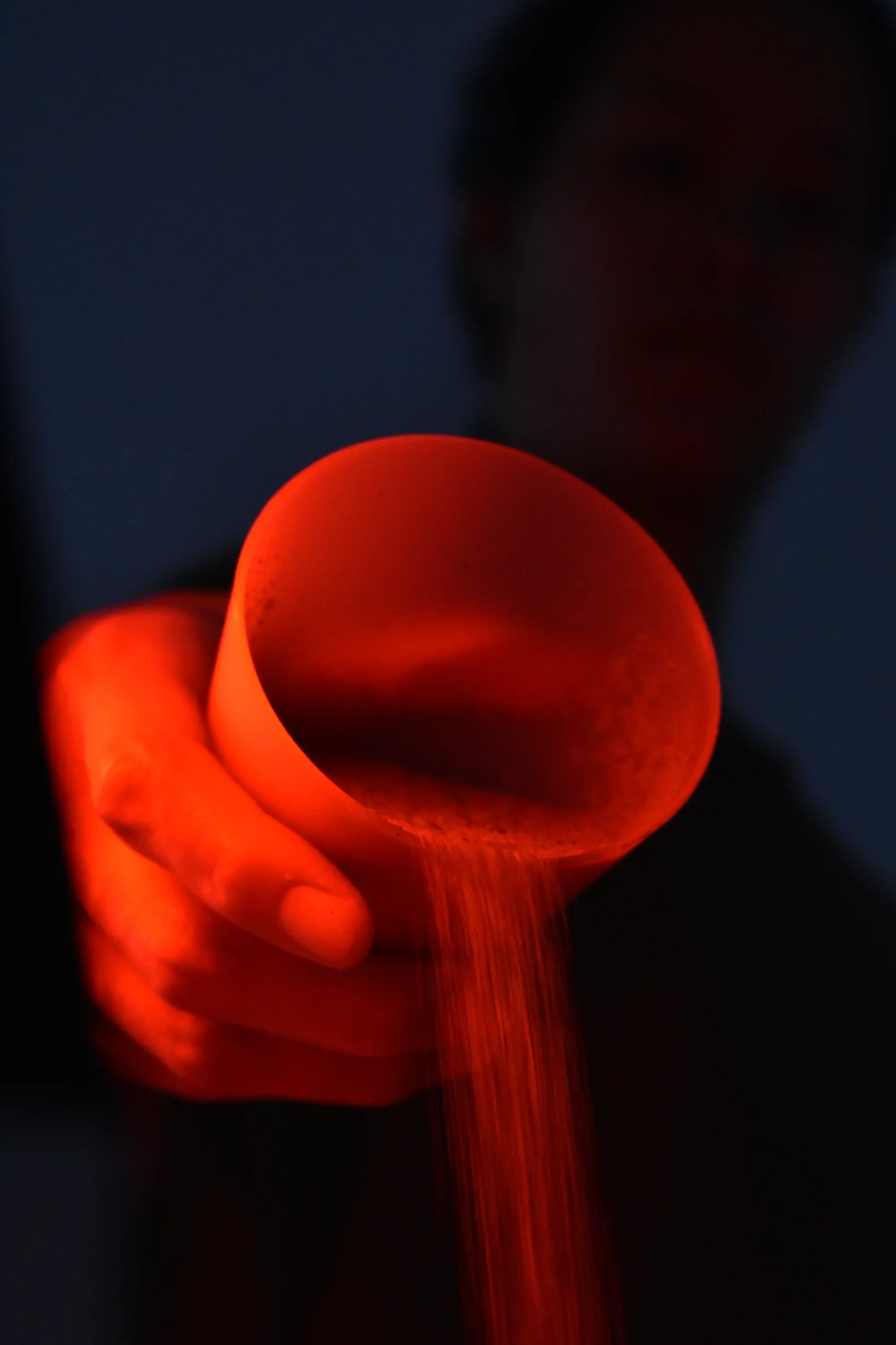 Closeup of a hand pouring sand